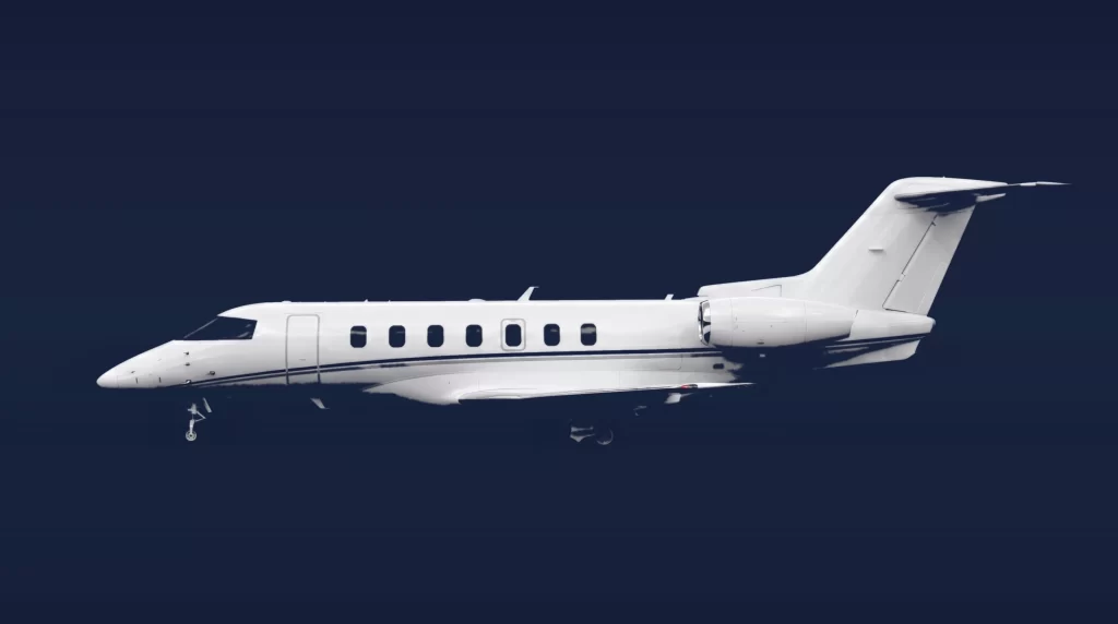 Pilatus PC-24 private charter aircraft, left-side profile on a deep navy studio background