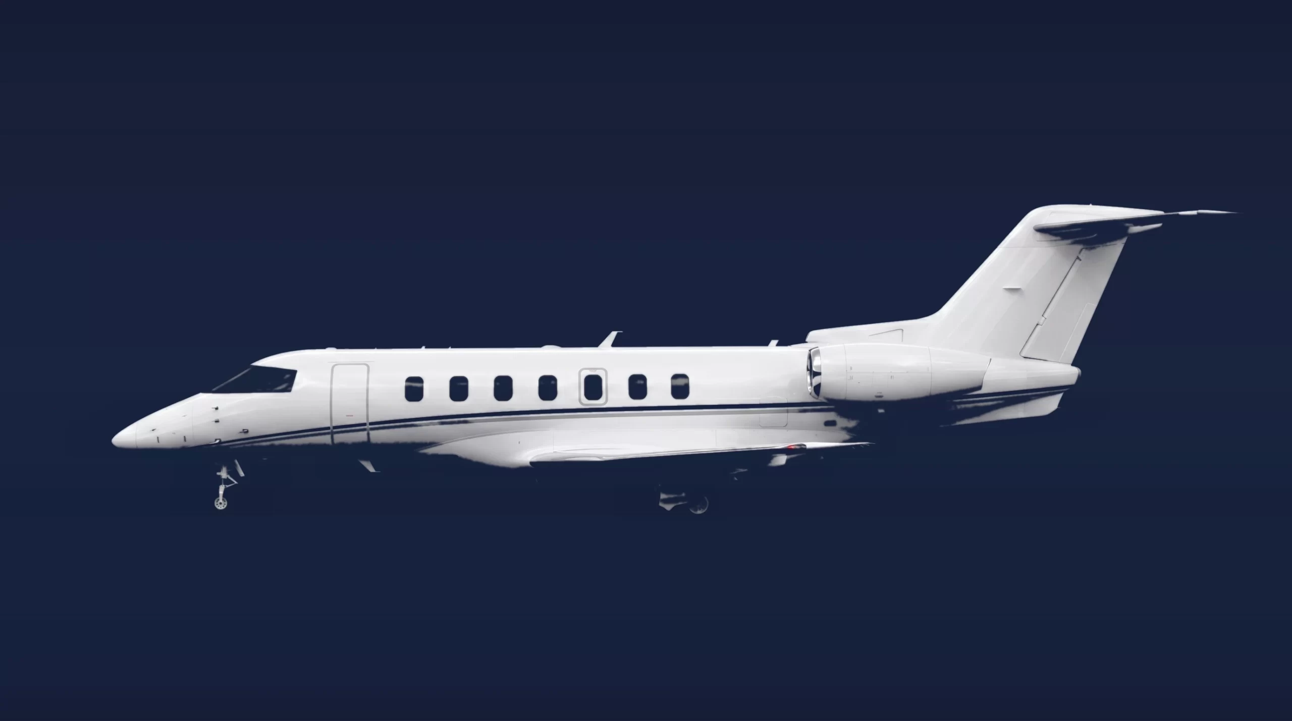 Pilatus PC-24 private charter aircraft, left-side profile on a deep navy studio background