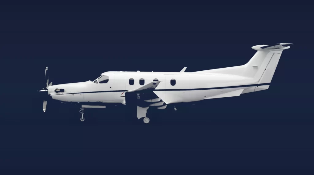 Pilatus PC-12 private charter aircraft, left-side profile on a deep navy studio background